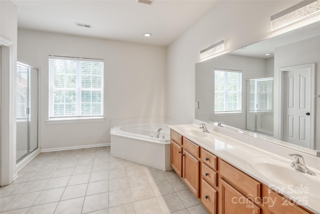2002 Ledare Ln Unit 70, Indian Trail, NC 28079 - full bathroom with double vanity, a stall shower, a bath, and tile patterned flooring