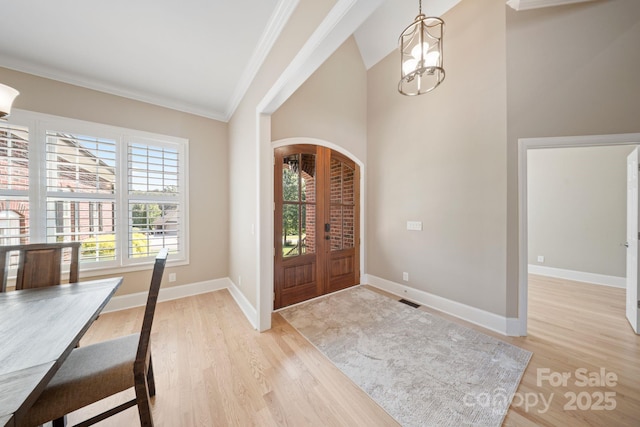 120 Cheyenne Ln, Statesville, NC 28677 - entryway featuring arched walkways, ornamental molding, light wood-style floors, a chandelier, and french doors
