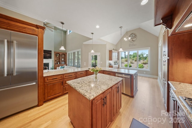 120 Cheyenne Ln, Statesville, NC 28677 - kitchen with stainless steel appliances, light wood-type flooring, a fireplace, a kitchen island, and recessed lighting