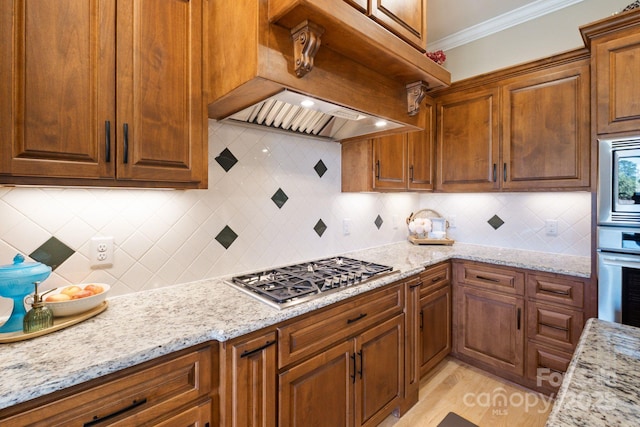 120 Cheyenne Ln, Statesville, NC 28677 - kitchen featuring appliances with stainless steel finishes, custom exhaust hood, backsplash, ornamental molding, and light stone countertops