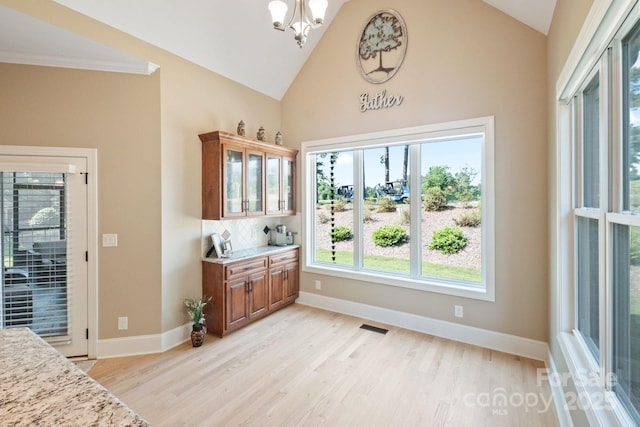 120 Cheyenne Ln, Statesville, NC 28677 - dining area with light wood-type flooring, a chandelier, and high vaulted ceiling