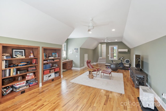 120 Cheyenne Ln, Statesville, NC 28677 - living room with a wall unit AC, lofted ceiling, light wood-type flooring, a ceiling fan, and stairs