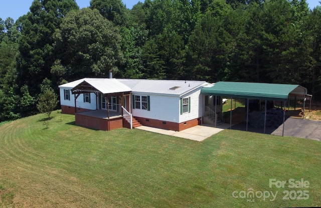1924 Junction Rd, Mocksville, NC 27028 - view of front of house with crawl space, a front yard, a carport, and a forest view