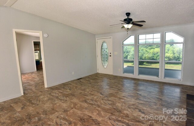 1924 Junction Rd, Mocksville, NC 27028 - unfurnished room featuring ceiling fan, stone finish floors, and a textured ceiling