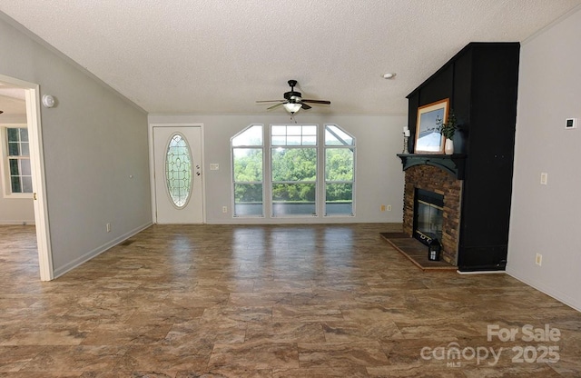 1924 Junction Rd, Mocksville, NC 27028 - unfurnished living room with a ceiling fan, a textured ceiling, and a glass covered fireplace