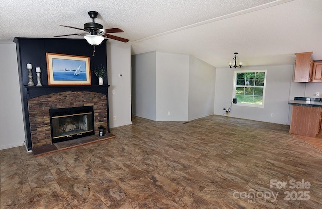 1924 Junction Rd, Mocksville, NC 27028 - unfurnished living room with a ceiling fan, a textured ceiling, a chandelier, and a brick fireplace