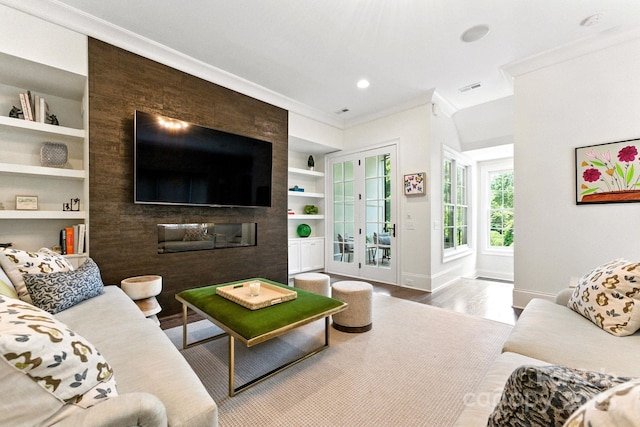 1614 Lombardy Cir, Charlotte, NC 28203 - living room with ornamental molding, built in shelves, wood finished floors, and recessed lighting