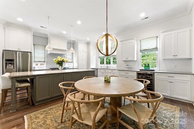 1614 Lombardy Cir, Charlotte, NC 28203 - dining area featuring beverage cooler, dark wood-type flooring, ornamental molding, and recessed lighting