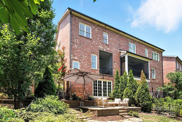 1614 Lombardy Cir, Charlotte, NC 28203 - back of house with brick siding, a patio, and ceiling fan