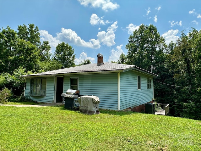 4207 Peach Orchard Rd, Granite Falls, NC 28630 - view of side of home with a metal roof, a yard, and a chimney