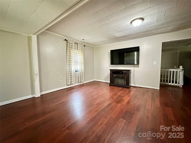 4207 Peach Orchard Rd, Granite Falls, NC 28630 - unfurnished living room featuring wood finished floors and a glass covered fireplace