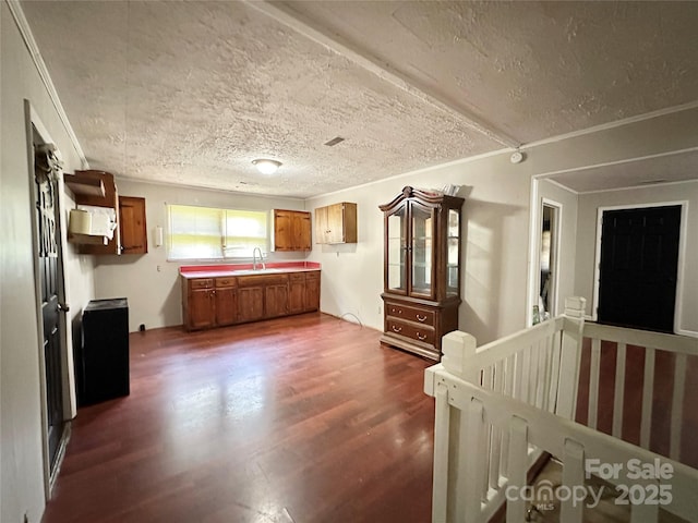4207 Peach Orchard Rd, Granite Falls, NC 28630 - kitchen featuring brown cabinets, dark wood-type flooring, a textured ceiling, and light countertops