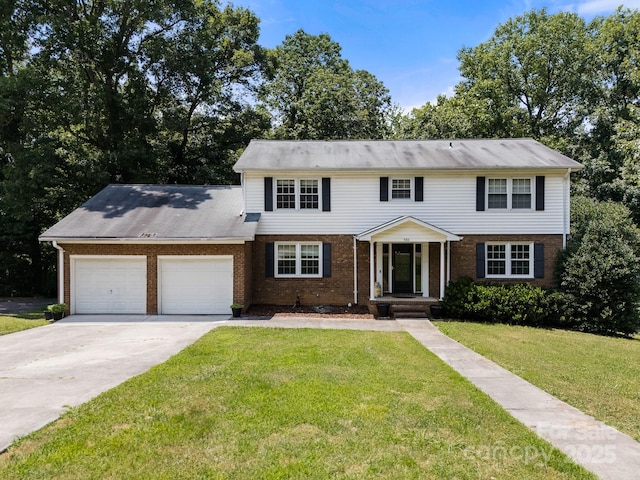 586 Crestside Dr SE, Concord, NC 28025 - colonial-style house featuring brick siding, an attached garage, driveway, and a front yard