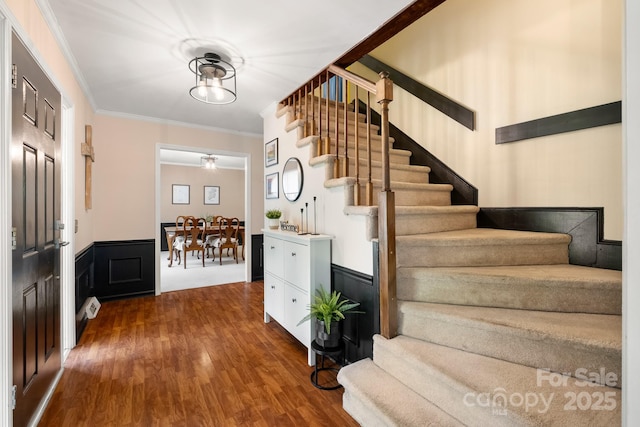 586 Crestside Dr SE, Concord, NC 28025 - foyer with stairs, dark wood-style floors, wainscoting, and ornamental molding