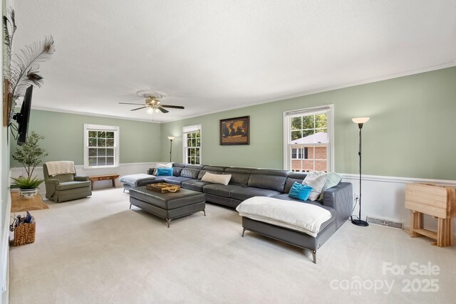 586 Crestside Dr SE, Concord, NC 28025 - living room featuring carpet flooring, ornamental molding, and a ceiling fan