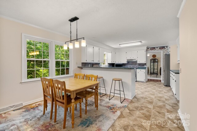 586 Crestside Dr SE, Concord, NC 28025 - dining space with ornamental molding