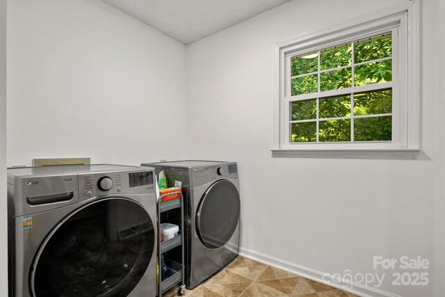 586 Crestside Dr SE, Concord, NC 28025 - laundry area featuring washer and dryer and baseboards