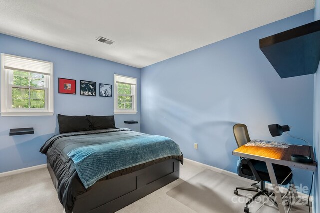 586 Crestside Dr SE, Concord, NC 28025 - carpeted bedroom with baseboards and a desk