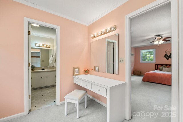 586 Crestside Dr SE, Concord, NC 28025 - ensuite bathroom with vanity, ornamental molding, and ceiling fan