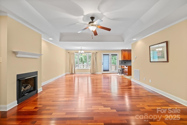 1566 Mayfair Dr, Conover, NC 28613 - unfurnished living room with a raised ceiling, light wood-style floors, ceiling fan, crown molding, and recessed lighting