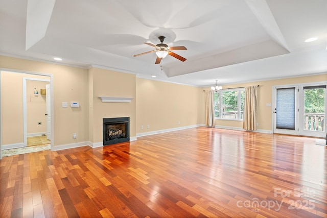 1566 Mayfair Dr, Conover, NC 28613 - unfurnished living room with a raised ceiling, light wood-type flooring, ceiling fan, a chandelier, and recessed lighting