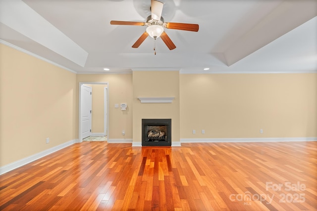 1566 Mayfair Dr, Conover, NC 28613 - unfurnished living room featuring a tray ceiling, light wood-type flooring, ceiling fan, ornamental molding, and a fireplace