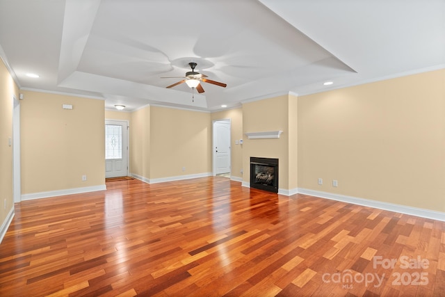 1566 Mayfair Dr, Conover, NC 28613 - unfurnished living room featuring a raised ceiling, ceiling fan, light wood-style flooring, recessed lighting, and ornamental molding