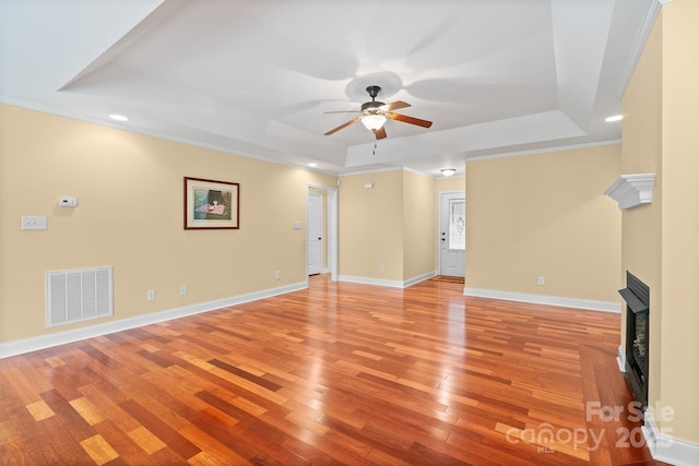 1566 Mayfair Dr, Conover, NC 28613 - unfurnished living room with a raised ceiling, ceiling fan, light wood-style floors, a fireplace, and recessed lighting