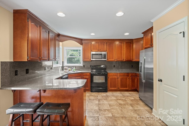 1566 Mayfair Dr, Conover, NC 28613 - kitchen featuring stainless steel appliances, a peninsula, ornamental molding, recessed lighting, and arched walkways