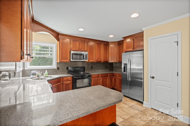 1566 Mayfair Dr, Conover, NC 28613 - kitchen with appliances with stainless steel finishes, crown molding, tasteful backsplash, a peninsula, and recessed lighting