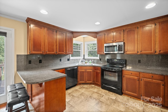 1566 Mayfair Dr, Conover, NC 28613 - kitchen featuring stainless steel microwave, black range with electric stovetop, dishwashing machine, a peninsula, and crown molding