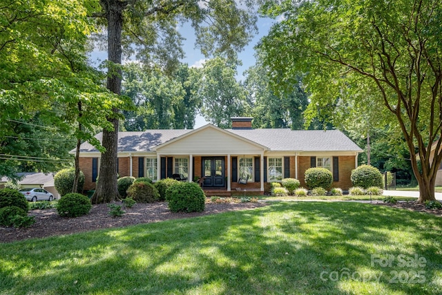 7119 Folger Dr, Charlotte, NC 28270 - single story home featuring brick siding, a front lawn, a porch, and a chimney