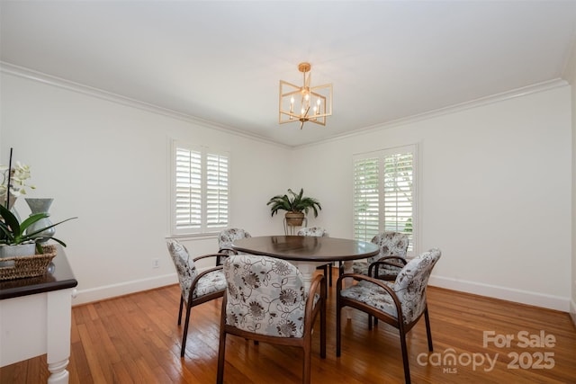 7119 Folger Dr, Charlotte, NC 28270 - dining room with a chandelier, crown molding, and light wood finished floors