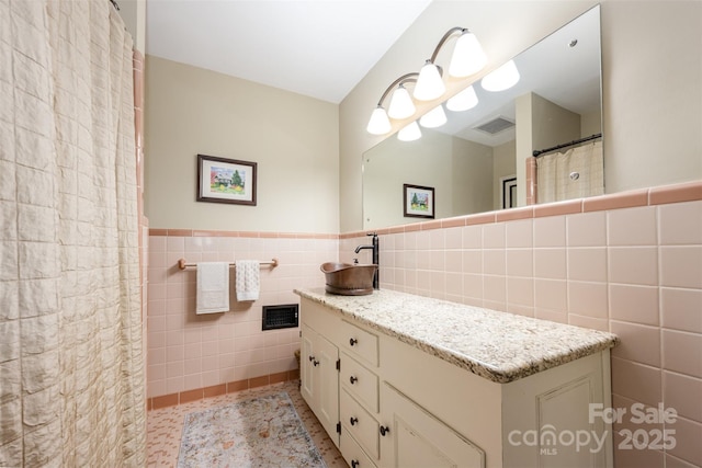 7119 Folger Dr, Charlotte, NC 28270 - full bath with tile walls, vanity, and a wainscoted wall