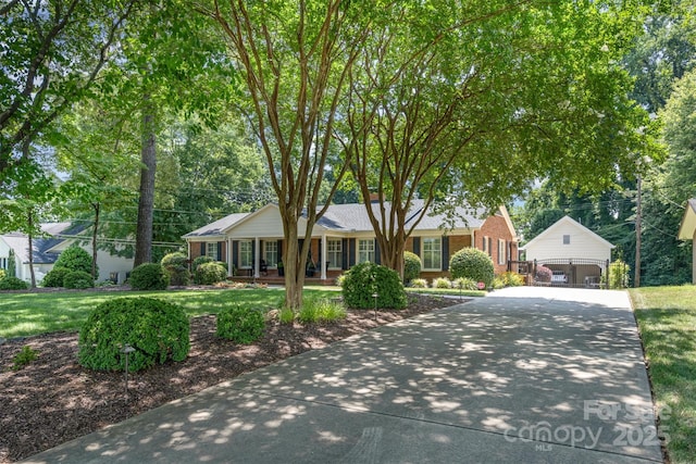 7119 Folger Dr, Charlotte, NC 28270 - single story home with a porch, a front yard, an outbuilding, and brick siding