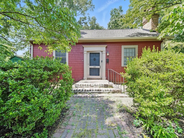 105 Edgewood Cir NE, Concord, NC 28025 - doorway to property featuring a chimney and roof with shingles