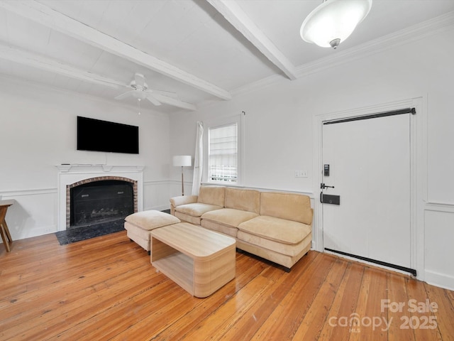 105 Edgewood Cir NE, Concord, NC 28025 - living room featuring beam ceiling, ceiling fan, light wood-style flooring, and a brick fireplace