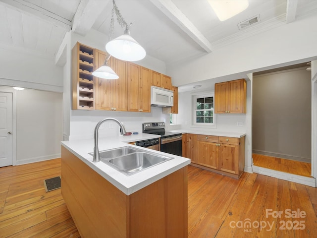 105 Edgewood Cir NE, Concord, NC 28025 - kitchen featuring white microwave, stainless steel range with electric stovetop, beam ceiling, light wood-style floors, and a peninsula