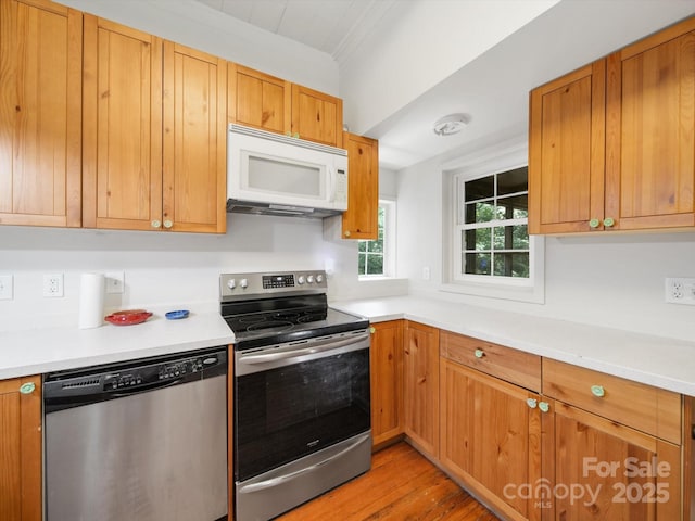 105 Edgewood Cir NE, Concord, NC 28025 - kitchen featuring appliances with stainless steel finishes, light wood-type flooring, light countertops, and brown cabinets