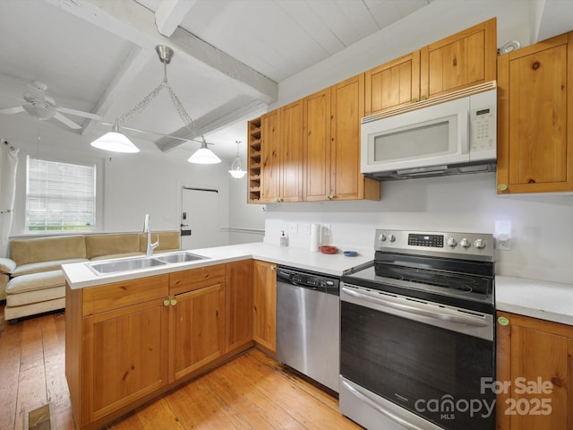 105 Edgewood Cir NE, Concord, NC 28025 - kitchen featuring appliances with stainless steel finishes, a peninsula, light wood-style floors, beam ceiling, and light countertops