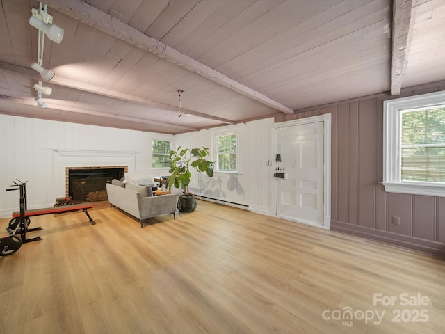 105 Edgewood Cir NE, Concord, NC 28025 - living room featuring a wood ceiling with exposed beams, wood finished floors, a baseboard radiator, and a fireplace
