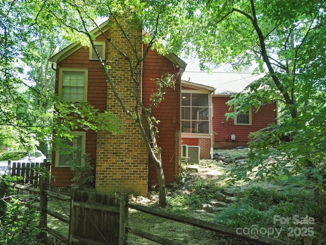 105 Edgewood Cir NE, Concord, NC 28025 - view of home's exterior featuring a chimney and a cooling unit