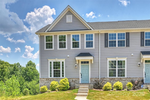 342 Cramerton Mills Parkway, Cramerton, NC 28032 - view of property featuring brick siding, a front lawn, and a shingled roof