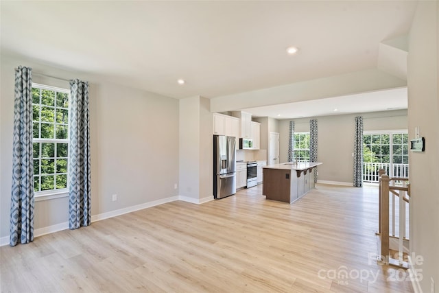 342 Cramerton Mills Parkway, Cramerton, NC 28032 - kitchen featuring appliances with stainless steel finishes, white cabinetry, healthy amount of natural light, light wood finished floors, and recessed lighting