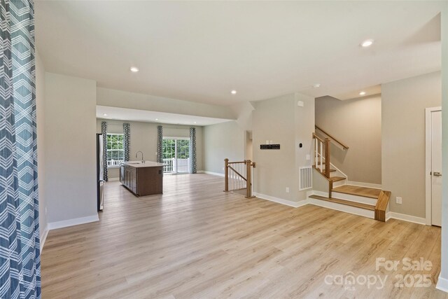 342 Cramerton Mills Parkway, Cramerton, NC 28032 - empty room with light wood finished floors, recessed lighting, and stairs