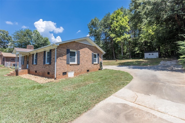 120 Lafayette Rd, Stanley, NC 28164 - view of side of home featuring brick siding, crawl space, a yard, a chimney, and driveway