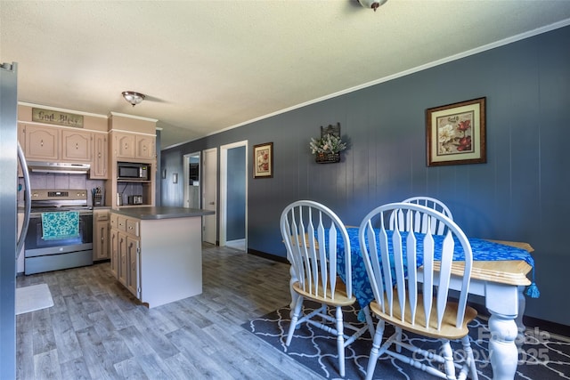 120 Lafayette Rd, Stanley, NC 28164 - kitchen with electric stove, under cabinet range hood, black microwave, ornamental molding, and light wood finished floors