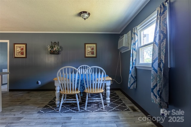 120 Lafayette Rd, Stanley, NC 28164 - dining space featuring a wall mounted air conditioner, wood finished floors, ornamental molding, and a textured ceiling