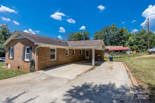 120 Lafayette Rd, Stanley, NC 28164 - view of front facade featuring brick siding, driveway, an attached carport, and a front lawn