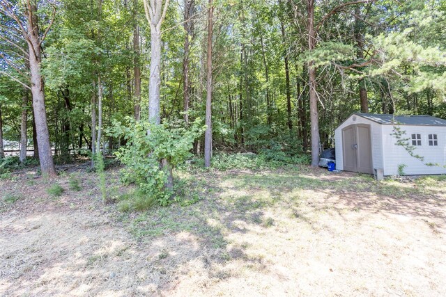 120 Lafayette Rd, Stanley, NC 28164 - view of yard with a storage unit and a view of trees